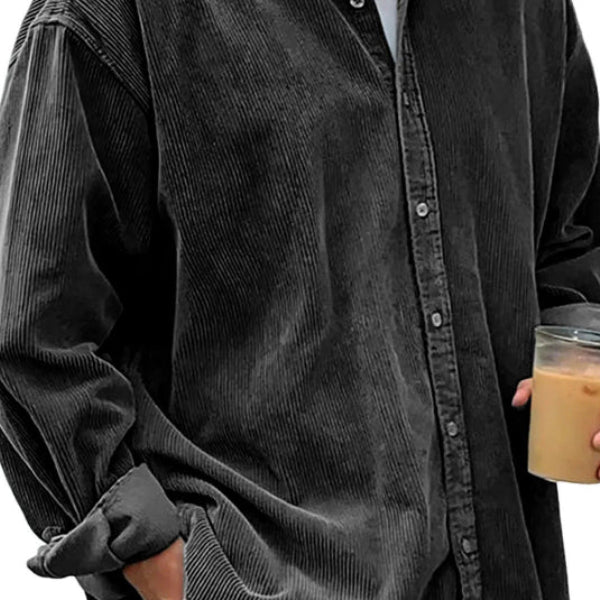 Person wearing a dark gray corduroy shirt holding a cup.