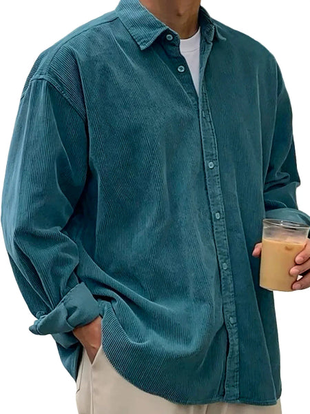 Person wearing a teal corduroy shirt holding a drink.