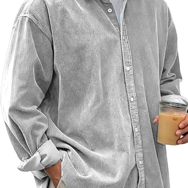 Person wearing a gray corduroy shirt holding a cup with a clear lid.